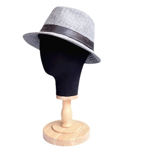 Detail view of a gray striped fedora hat on a mannequin head with wooden base stand