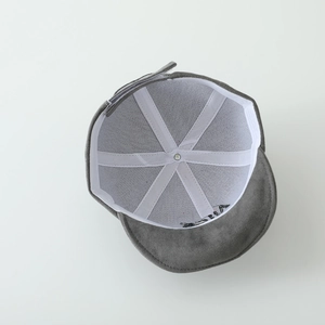 Detail view of baby suede cap interior with reinforced seams and embroidery