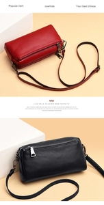 Detail of red and black cowhide leather handbags with multiple zippers and adjustable straps