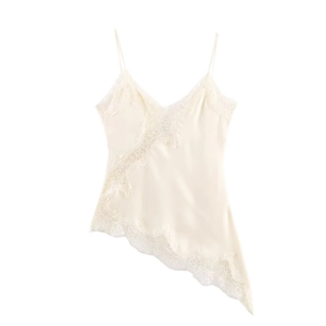 Detail of ivory satin camisole featuring delicate lace trim and irregular hemline