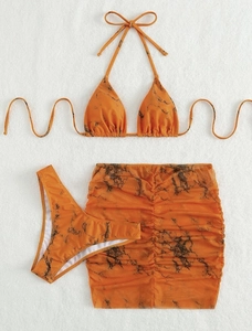 Detail of orange marble print bikini set with ruched drawstring mesh skirt on white texture