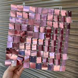 Detail of rose gold square sequin wall panel with metallic mirror finish for events