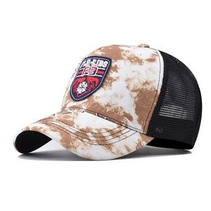 Detail of retro tie-dye trucker hat with H-KIDS patch and breathable black mesh back