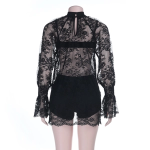 Detail of black floral lace romper featuring open back button closure and flared cuffs