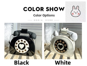Detail view of vintage telephone-shaped handbags in glossy black and white patent leather