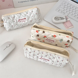 Détails de trousses à maquillage en coton matelassé aux motifs de fleurs, ours et cerises