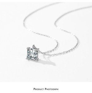Macro view of square cut cubic zirconia pendant on a fine silver link chain necklace