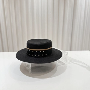 Detail of elegant black boater hat featuring rhinestone ribbon and V-pattern texture