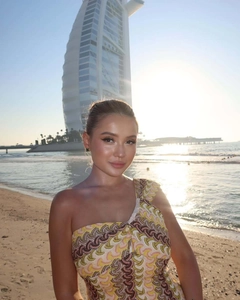 Detail of the wave pattern print and one-shoulder cut on a slim beach vacation dress