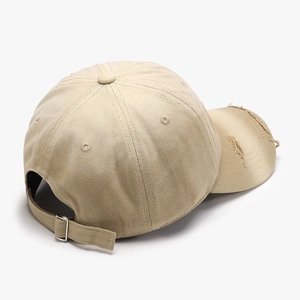 Beige washed cotton baseball cap with distressed details and adjustable metal buckle