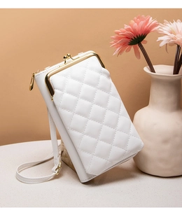 Detailed view of white quilted crossbody phone bag with gold metal clasp and floral accents