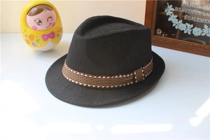 Close-up of black straw jazz hat with striped ribbon detail and vintage props