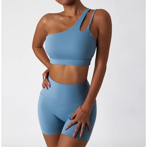 Detail of blue one-shoulder cutout sports bra and high-waist shorts yoga set