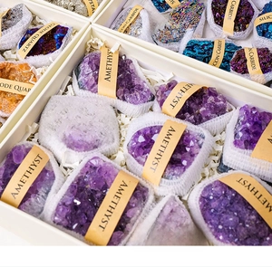 Top view of natural amethyst, silicon carbide and quartz geodes in a labeled gift box