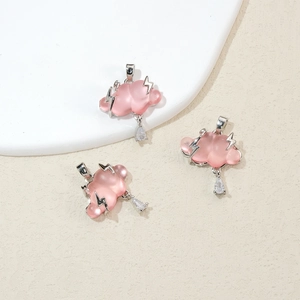 Close-up of pink cloud pendants with silver lightning and crystal raindrop charms