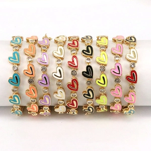 Detail of colorful enamel heart bracelets with zircon centerpieces on white display stands