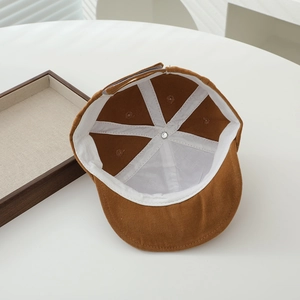 Close-up of baby baseball cap interior showing white reinforcing tape and stitching