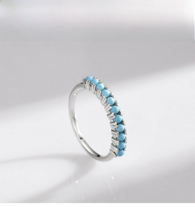 Detail of 925 sterling silver ring with eleven small turquoise stones in a row