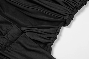 Detail view of the black dress featuring mesh splicing and fine side ruching craftsmanship
