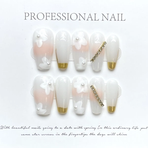 Detail of handmade cat-eye press-on nails featuring 3D white flowers and pearl accents