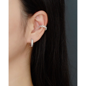 Close-up of 925 sterling silver ear cuff and huggie hoop with sparkling zircon stones