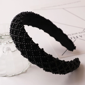 Detail of hand-beaded black pearl headband with elegant diamond pattern weaving