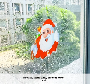 Detail eines statischen Weihnachtsfensteraufklebers mit Weihnachtsmann auf nassem Glas
