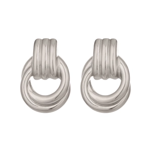 Detail of silver geometric hoop earrings with vertical textured relief and polished finish