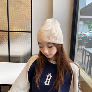 Outdoor winter knit beanie in cream white with mountain embroidery and cuffed design