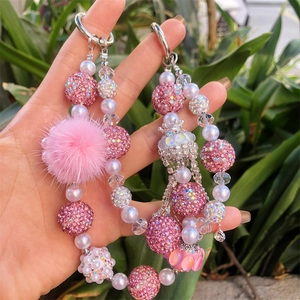 Detail of handmade beaded charm with pink disco ball and white faux pearls