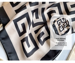 Detail of premium houndstooth silk scarf showing fine flat-seam stitched edge quality