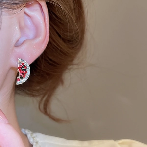 Close-up of a sparkling rhinestone watermelon stud earring worn on a model ear