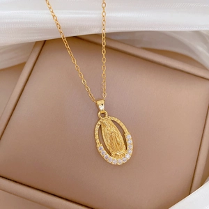 Close-up of golden oval portrait pendant with small diamonds in a jewelry box