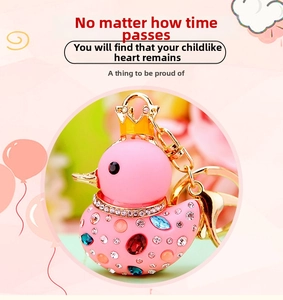 Detail of pink crystal duck keychain with gold crown and multicolored rhinestones