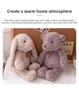 Detail of plush beige bunny and purple bear with soft long-pile fur in a cozy setting