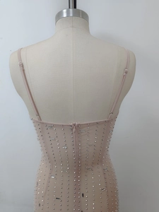 Close-up of mesh fabric with sparkling rhinestones and invisible back zipper of the dress