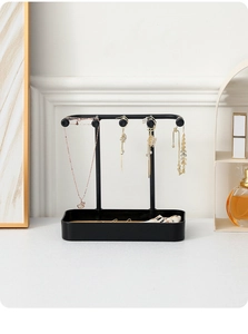 Detail of black jewelry organizer with rectangular tray and T-bar for necklaces