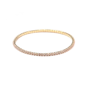 Close-up of a single row 2.0mm gold crystal tennis bracelet with white rhinestones
