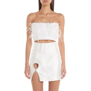 Close-up of white ostrich feather top and satin skirt with heart cutout detail