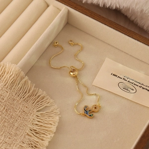 Detail of gold adjustable box chain bracelet with colorful abalone shell inlay