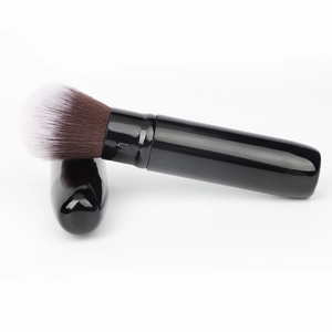 Portable black retractable makeup brush with dual-tone synthetic bristles for travel use