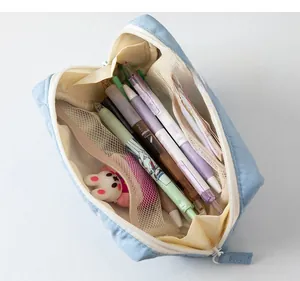 Detail view of large capacity light blue pencil case with interior mesh pocket compartments