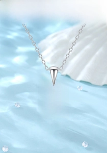 Detail of S925 silver necklace with square light blue zircon pendant on blue silk