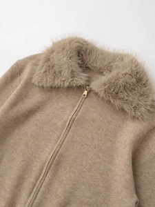 Detail of camel knitted jacket featuring a plush faux fur collar and metal zipper closure