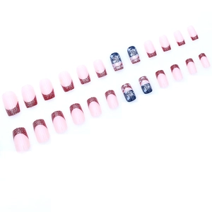 Short square press-on nails with red glitter French tips and blue star patterns