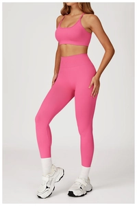 Macro detail of high-elastic ribbed rose red yoga set with cross-back sports bra and leggings