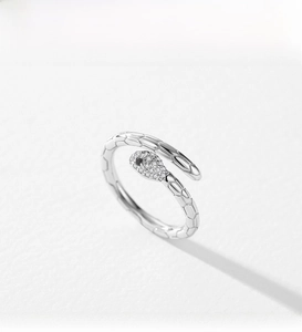 Macro detail of S925 sterling silver snake ring with white cubic zirconia and scale texture