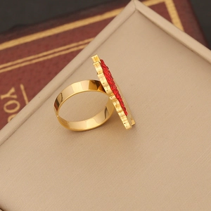 Detailed macro view of an adjustable gold ring with maple leaf inlaid red crystals