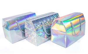 Holographic gift boxes with glitter, mosaic, and mirror textures plus silver rope handles