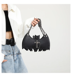 Close-up of black bat-shaped jelly bag with silver cross charm and metal chain strap